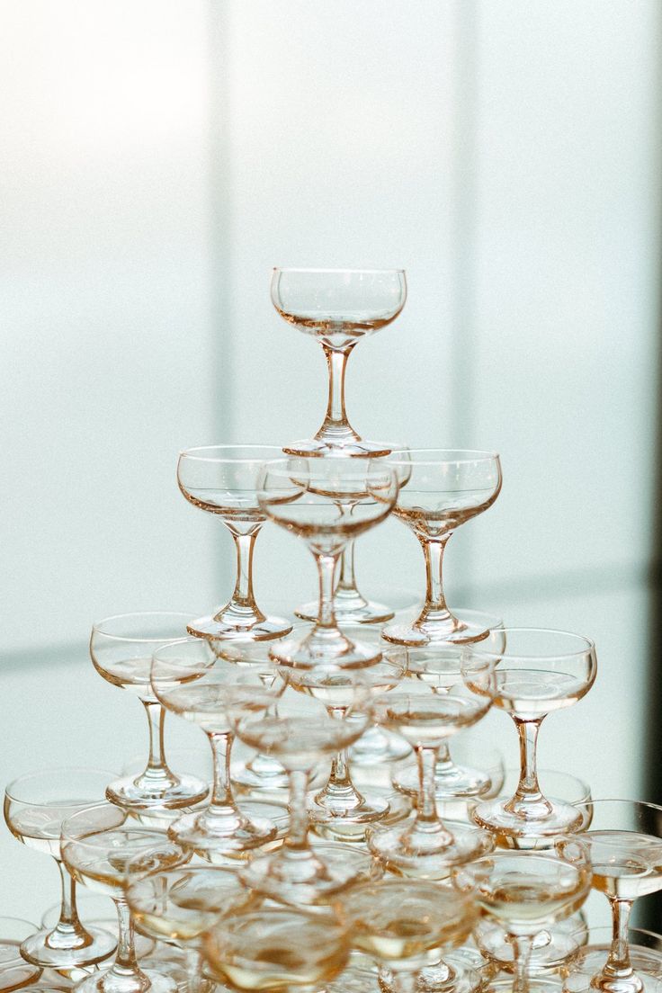 there are many wine glasses stacked on top of each other