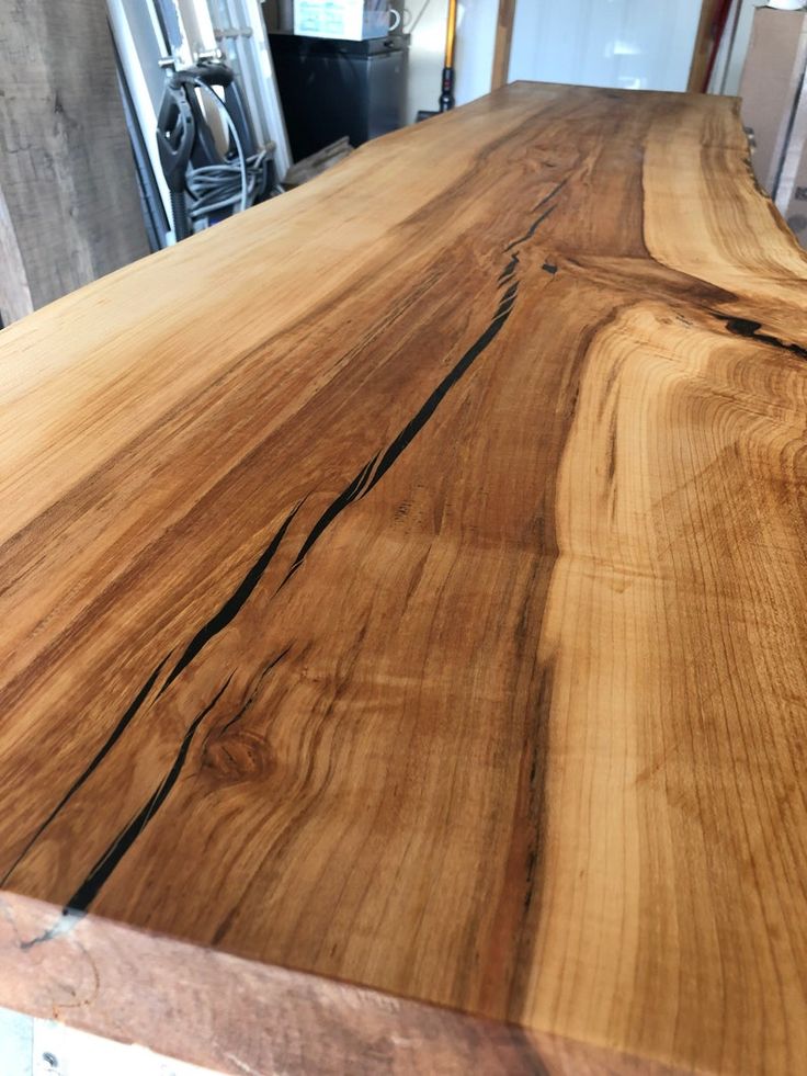 a large wooden table top sitting in a room