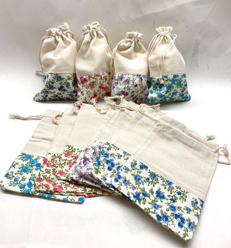 six small draws are lined up in different colors and patterns, each with flowers on them