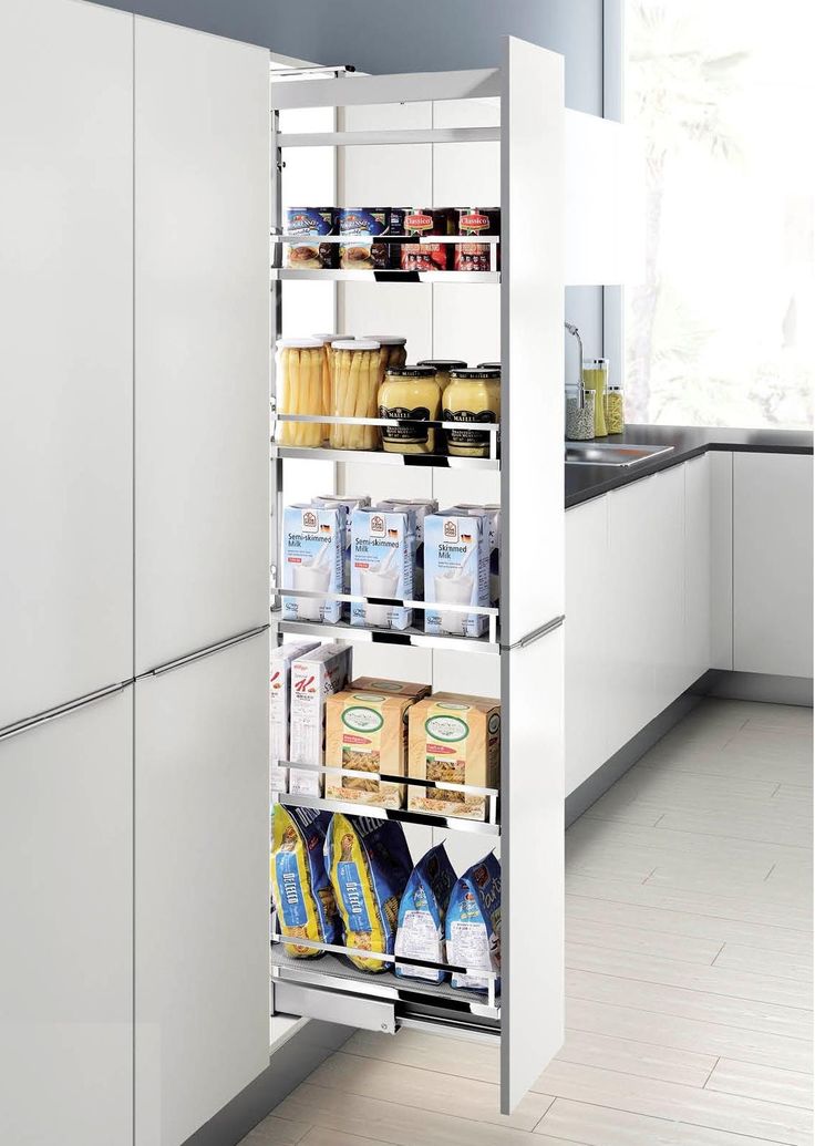 a kitchen with white cabinets and shelves filled with food