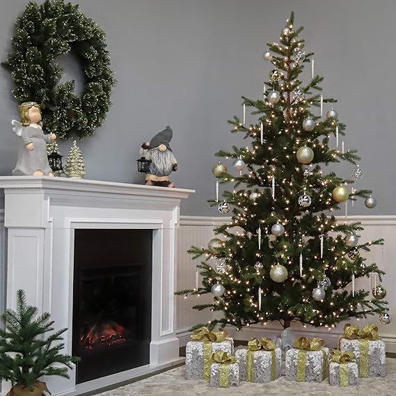 a decorated christmas tree sitting in front of a fireplace