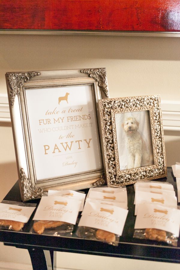 a table topped with framed pictures and cookies