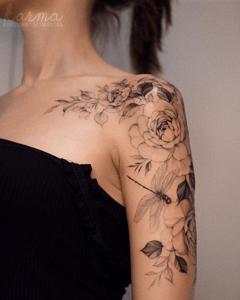 a woman with a flower tattoo on her shoulder