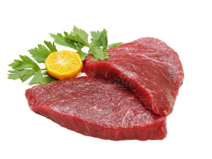 two raw meats with parsley and an orange slice on white background stock photo