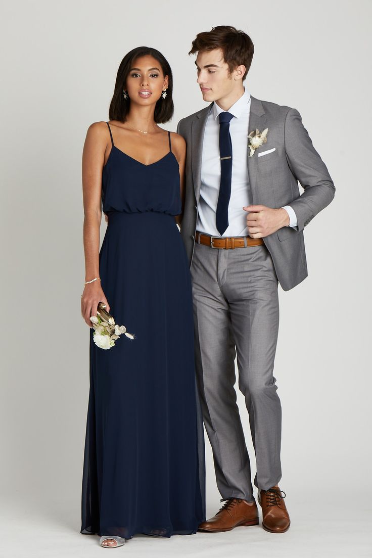 a man and woman in formal wear standing next to each other