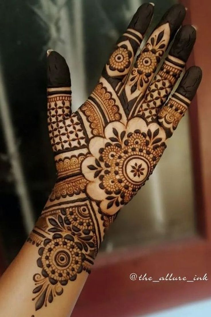 a woman's hand is decorated with hennap and intricate designs on it