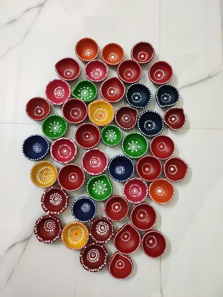 a group of colorful bottle caps sitting on top of a white counter next to a marble floor