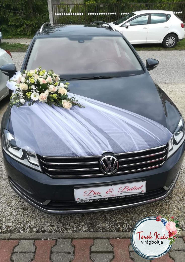 a black car with flowers on the hood