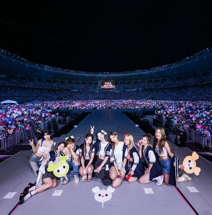 a group of young women standing on top of a stage in front of an audience