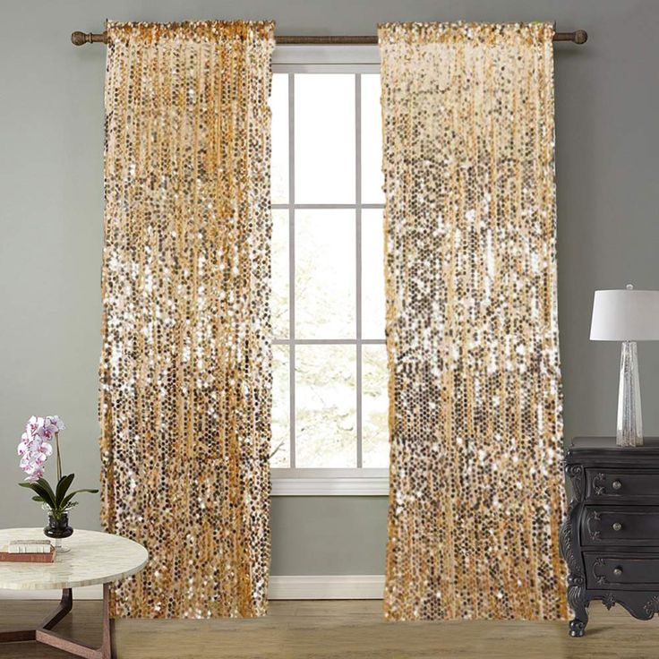 a living room with a window covered in gold sequins