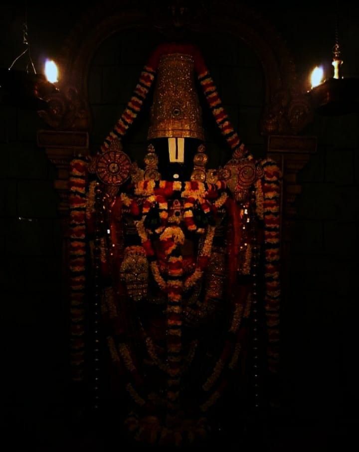 an intricately decorated statue is lit up in the dark