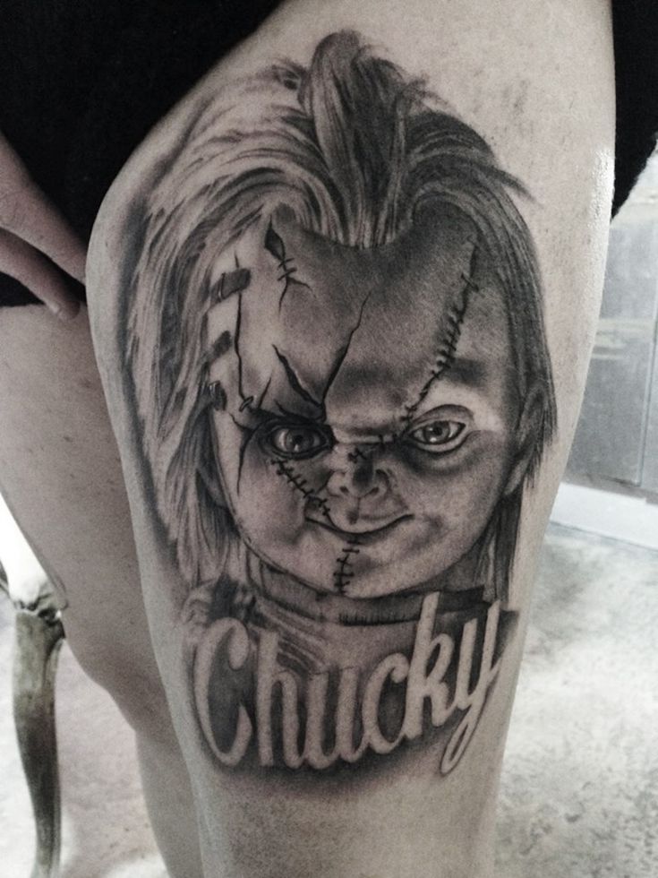 a close up of a person with a tattoo on their leg that says chucky