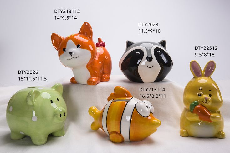 four ceramic animal figurines sitting on top of a white sheet with numbers in the background