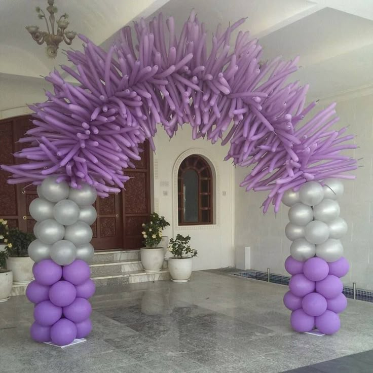 purple and silver balloons are on the ground