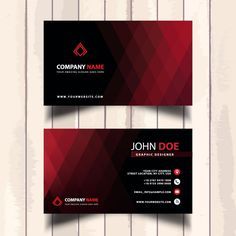 two red and black business cards on wooden background