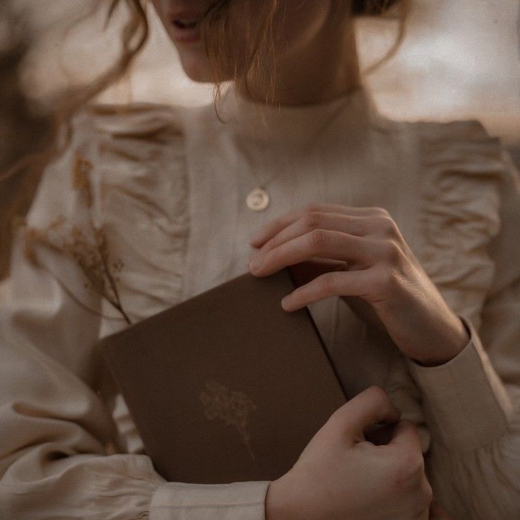 a woman holding a book in her hands