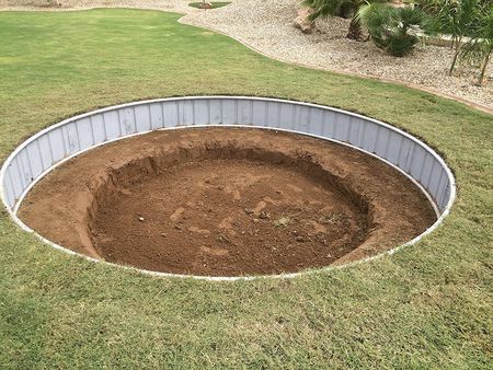 an empty pool in the middle of a yard