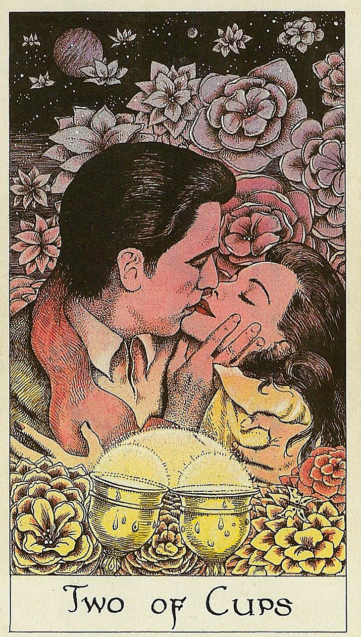 a couple kissing in front of flowers with the words two of cups written below them