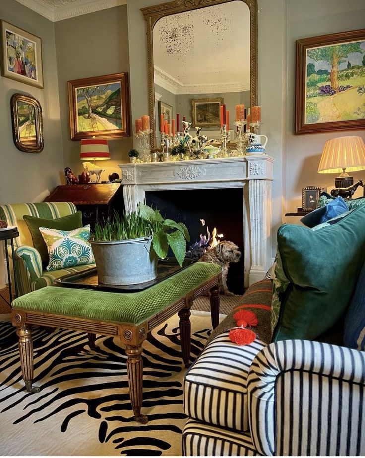 a living room filled with furniture and a fire place under a mirror on the wall