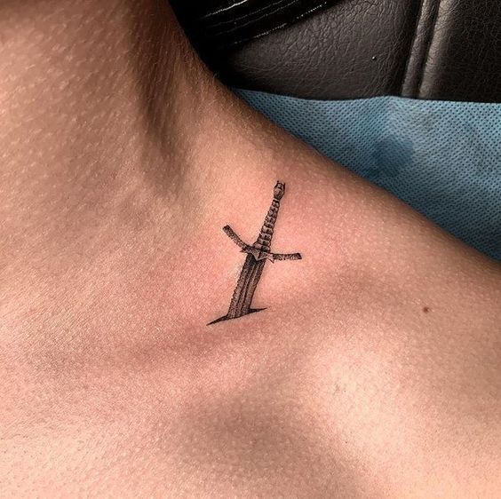 a cross tattoo on the chest