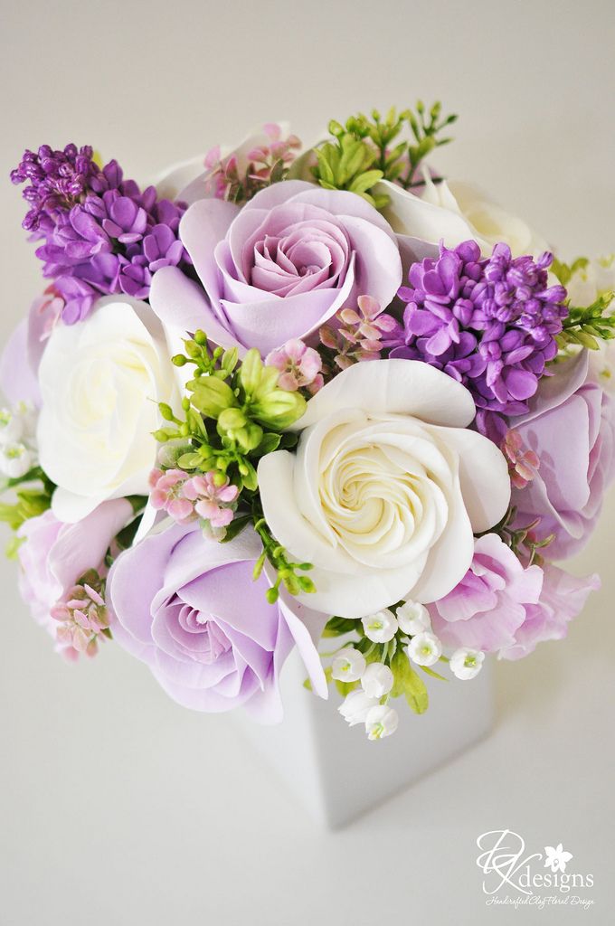 a bouquet of flowers sitting on top of a table next to an inscription in russian