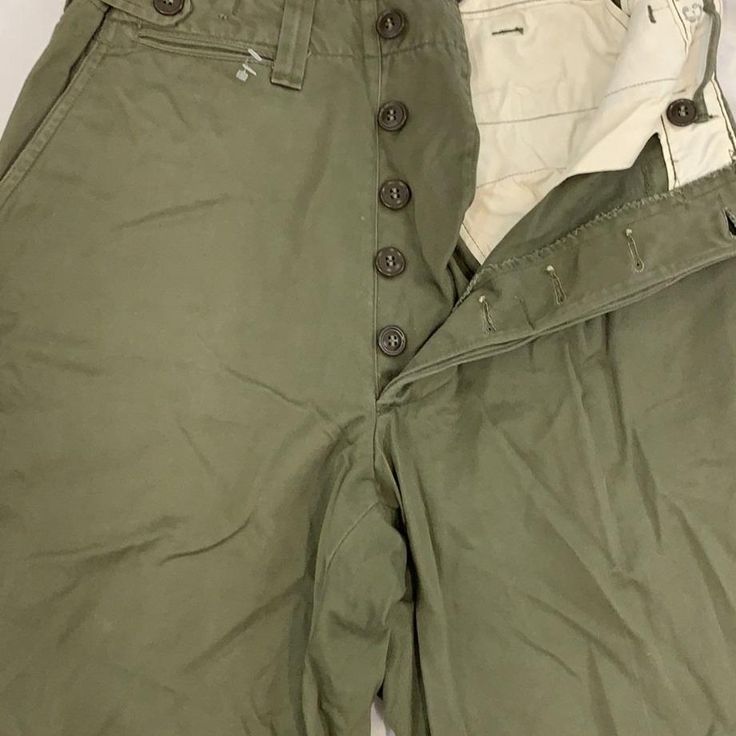 Vintage military work wear pants 1930-50s size: 28” inseam-31” Military Style Khaki Wide Leg Bottoms, Military Style Wide Leg Khaki Bottoms, Utility Full Length Pants With Button Closure, Military Style Cotton Parachute Pants, Full Length Military Cotton Bottoms, Utility Khaki Pants With Button Closure, Khaki Utility Pants With Button Closure, Vintage Khaki Cargo Bottoms, Military Style Wide Leg Work Pants