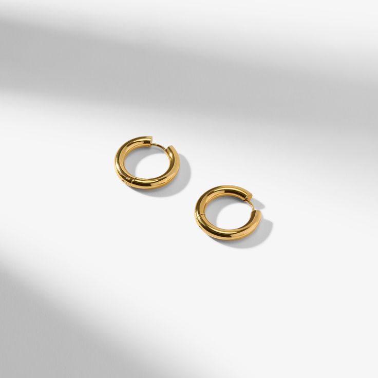 Inspired by our best-selling Claressa earrings, these hypoallergenic hoops are simple, beautiful, and timeless. They feature the same classic shape as the Claressa earrings, but they’re a bit smaller and thicker. Pair with the Claude charms for a delicate statement. Made from stainless steel with 18K-yellow-gold ion plating. Classic Hoop Single Ear Cuff, Classic Hoop Ear Cuff Single Earring, Classic Gold Hoop Ear Cuff, Classic Gold Plated Single Cartilage Earring, Classic Gold Hypoallergenic Cartilage Earrings, Classic Hypoallergenic Ear Cuff, Classic Gold Plated Ear Cuff, Classic Gold-plated Tarnish-resistant Ear Cuff, Classic Round Hypoallergenic Ear Cuff