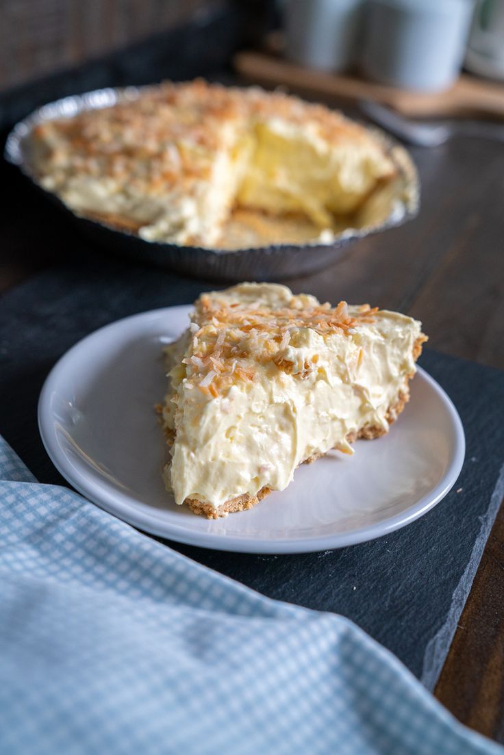 a piece of pie sitting on top of a white plate next to a pie pan