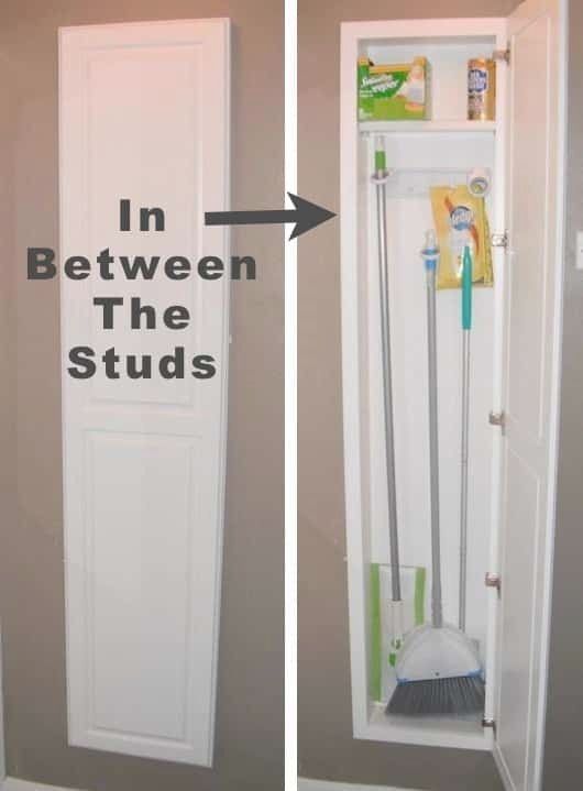 an open door with two brooms and cleaning supplies in between the studs on the wall