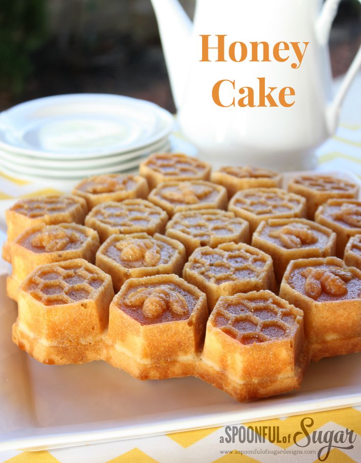 honey cake on a plate with plates and teapot in the backgroung