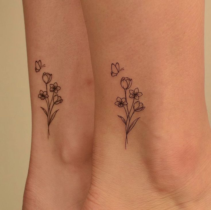 two small tattoos with flowers on their legs