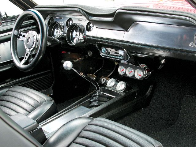 the interior of an old car with leather seats and steering wheel, including dash board