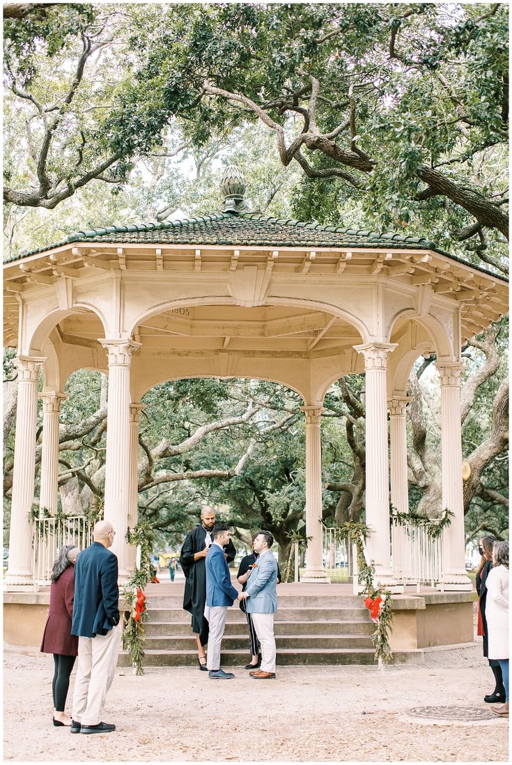 a group of people standing in front of a gazebo