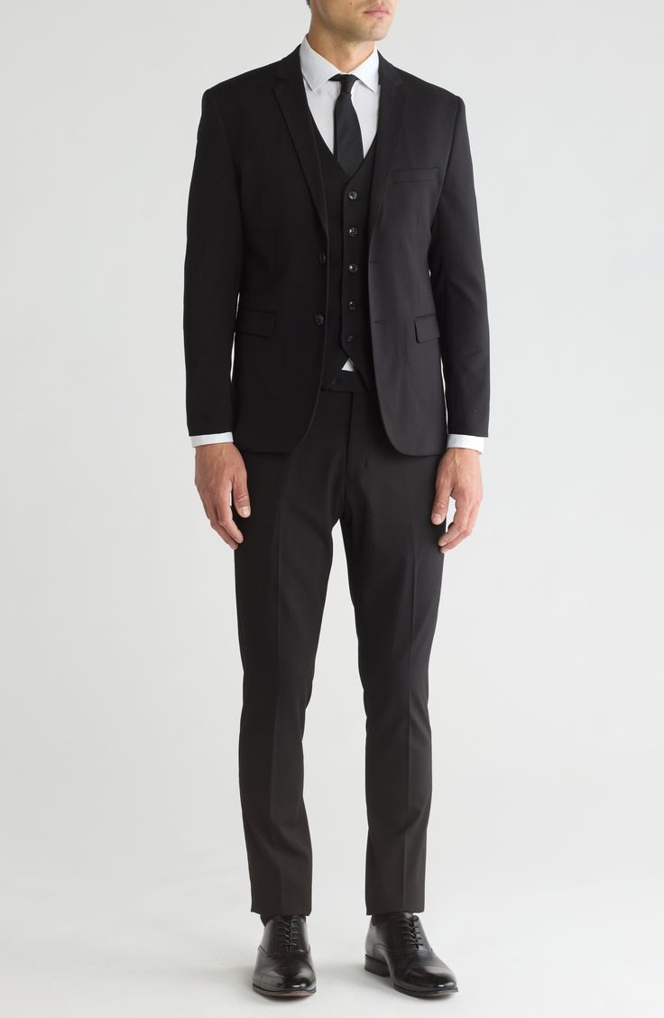 Stretch construction and a skinny cut mean modern appeal from a head-turning three-piece suit. Jacket has notched lapels; chest welt pocket; front welt pockets Vest has front button closure; V-neck Pants have zip fly with button closure; front slant pockets; back button-welt pockets Jacket and vest are lined; trousers are lined to the knee 62% polyester, 35% viscose, 3% spandex Dry clean Imported Each suit has a 6” drop, meaning that a size 38R jacket is paired with size 32 pants Slim Fit Three-piece Suit With Welt Pockets, Fitted Single Breasted Three-piece Suit With Notch Lapel, Slim Fit Three-piece Suit With Notch Lapel For Office, Three-piece Suit With Welt Pockets For Office, Three-piece Office Wear Suit With Welt Pockets, Slim Fit Single Breasted Three-piece Suit For Business Casual, Business Casual Slim Fit Three-piece Suit, Tailored Single Breasted Tuxedo For Work, Tuxedo Style Three-piece Suit With Pockets