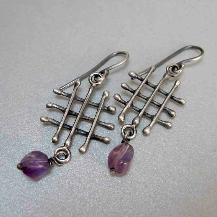 Rustic silver dangle earrings and amethyst, I made the grid pattern by welding short segments of 18 gauge silver wire, the amethyst gives color and movement. weight 0,09 oz each They are particular and original jewels, in a rustic and modern style. The craftsmanship makes them different from each other. Thank you for visiting and if you liked my shop add it to your favorites so you will be updated on news and new listings. You can also find me on Instagram; @Petrahjewelry Facebook: @Petrahandmad Silver Amethyst Wire Wrapped Earrings, Modern Purple Sterling Silver Earrings, Purple Modern Sterling Silver Earrings, Modern Purple Metal Jewelry, Short Silver Necklace, Handmade Jewel, Earrings Inspiration, Silver Dangle Earrings, Silver Chain Bracelet