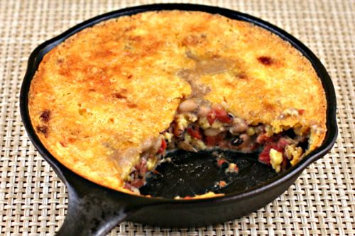 a skillet filled with food sitting on top of a table