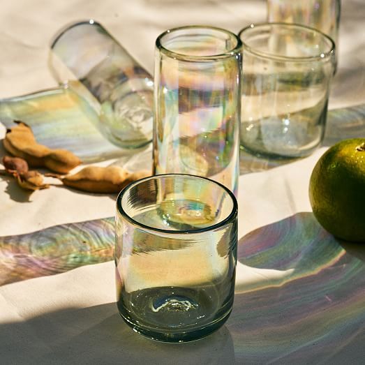 three glasses and an apple on a table