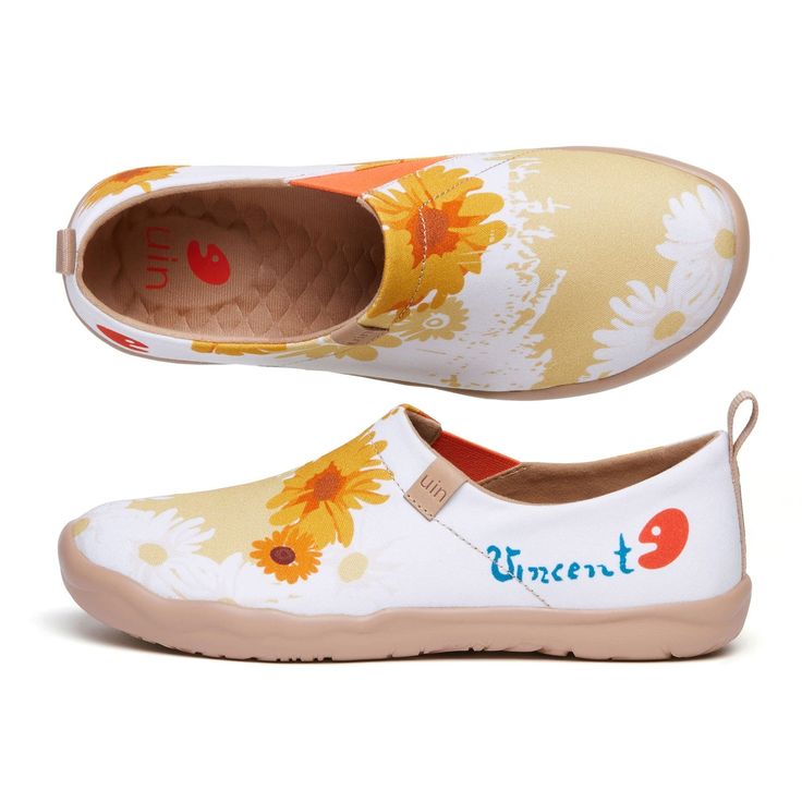 a pair of white and yellow shoes with sunflowers on them