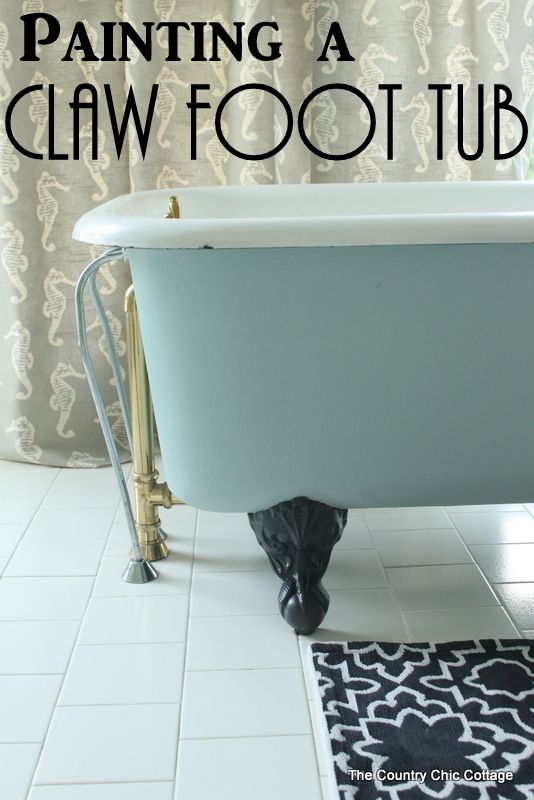 a claw foot tub sitting on top of a white tiled floor