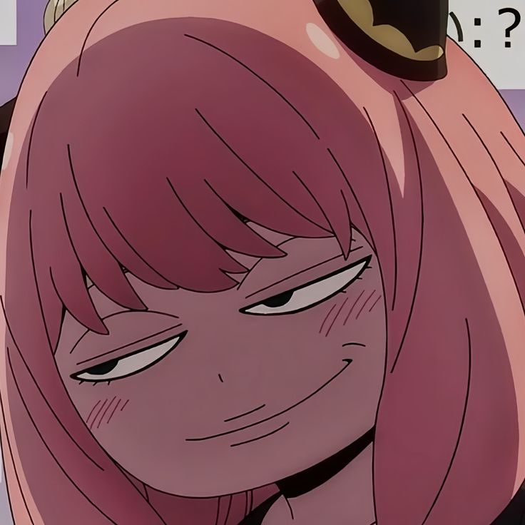 a close up of a person with pink hair and an anime character in the background