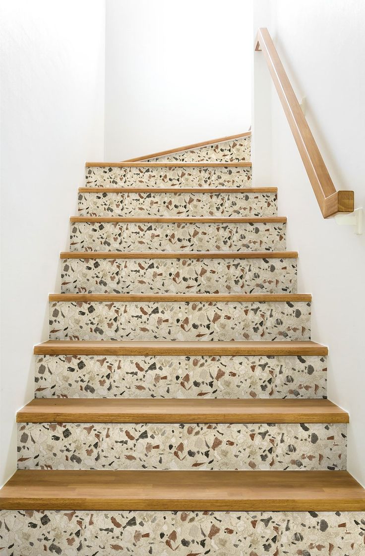 a set of stairs leading up to the top floor in a home with white walls and wood handrails