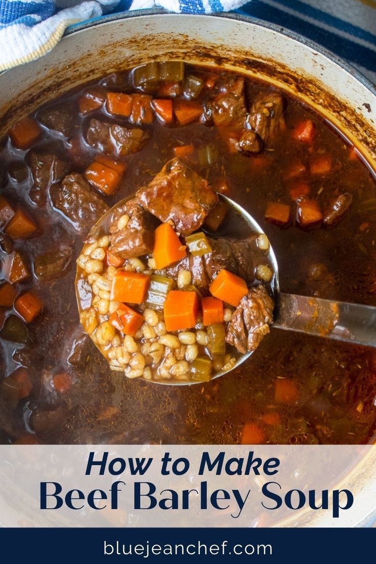 beef barley soup with carrots and potatoes in a large pot on top of a blue towel