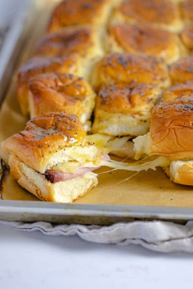 a tray with some sandwiches cut in half and on top of each other, ready to be eaten