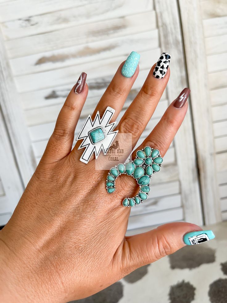 "Turquoise and silver Aztec ring Made with natural stone and brushed silver Measures: L 1.75\" x W 1\" This ring is adjustable! Gently pull or push the cuff to fit your fingerThis would make a great gift for the Western jewelry lover in your life!  Click here to be taken to our other rings: https://www.etsy.com/shop/CactusAndCoralInc?section_id=39978557 Click here to be taken to our Western chokers: https://www.etsy.com/shop/CactusAndCoralInc?section_id=39808176 Join us to be notified of new releases and exclusive discounts!  https://linktr.ee/cactusandcoral Thank you for stopping by. Have a blessed day! Sincerely, The Cactus and Coral Crew Western Stone and Silver Oval Statement Ring| Adjustable Big Southwestern Ring| Punchy Western Jewelry| Turquoise, White, Pink, Black Ring" Turquoise Western Nails, Punchy Western Nails, Western Chokers, Nfr Rodeo, Aztec Rings, Western Bachelorette, Rodeo Jewelry, Western Rings, Western Nails