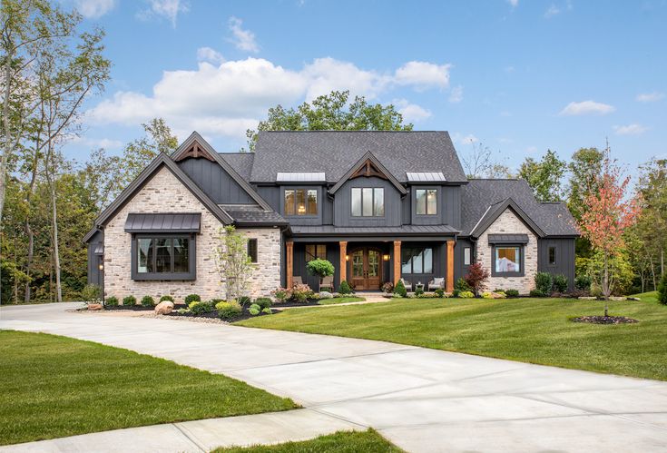 a large house with lots of windows and grass