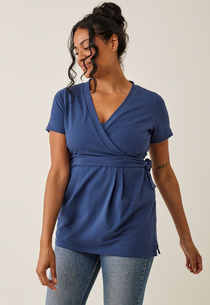 A soft and stretchy wrap top, thoughtfully designed to flatter your growing belly while discreetly offering effortless nursing access. The wide cuff on the sleeves can be worn up or down for added versatility. With an elastic band at the back, it accentuates your waistline, creating a flattering silhouette. This is the perfect, versatile everyday essential for moms at all stages!


Soft and stretchy cotton jersey
Sustainable material: 92% organic cotton and 8% elastane
Made in Portugal by Erius Versatile Wrap Top For Layering, Fitted Maternity Tops, Casual Fitted Short Sleeve Wrap Top, Nursing-friendly Fitted Top With Short Sleeves, Fitted Cotton Nursing-friendly Tops, Fitted Nursing Friendly Cotton Top, Fitted Nursing Friendly Top With Short Sleeves, Nursing Friendly Fitted Short Sleeve Tops, Fitted Short Sleeve Nursing-friendly Top