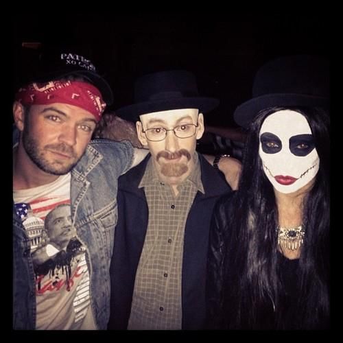 three people with masks on their faces posing for a photo in front of the camera