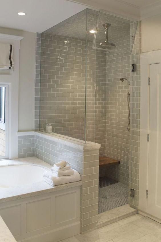 a bathroom with a walk in shower next to a bath tub