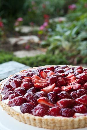 a strawberry pie sitting on top of a white plate