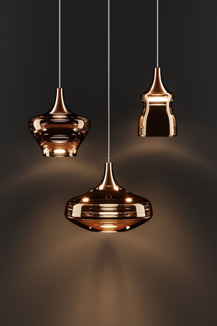 three lights that are hanging from the ceiling in different shapes and sizes, with one light turned on